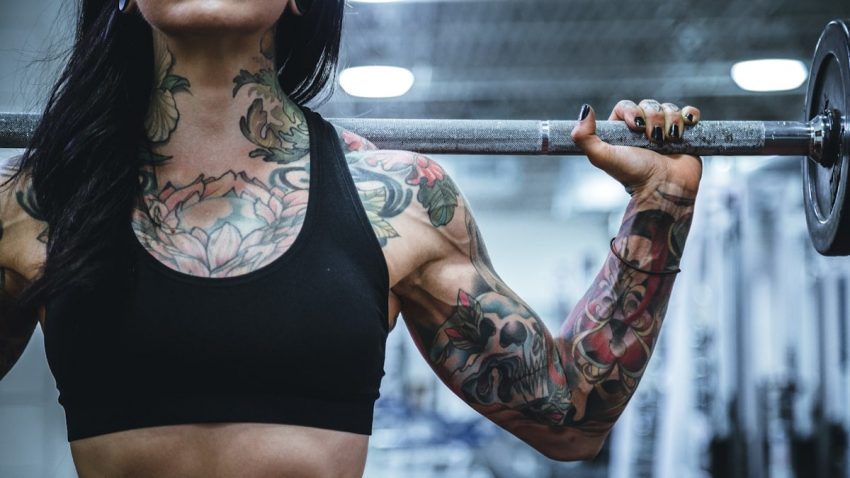 woman carrying barbell
